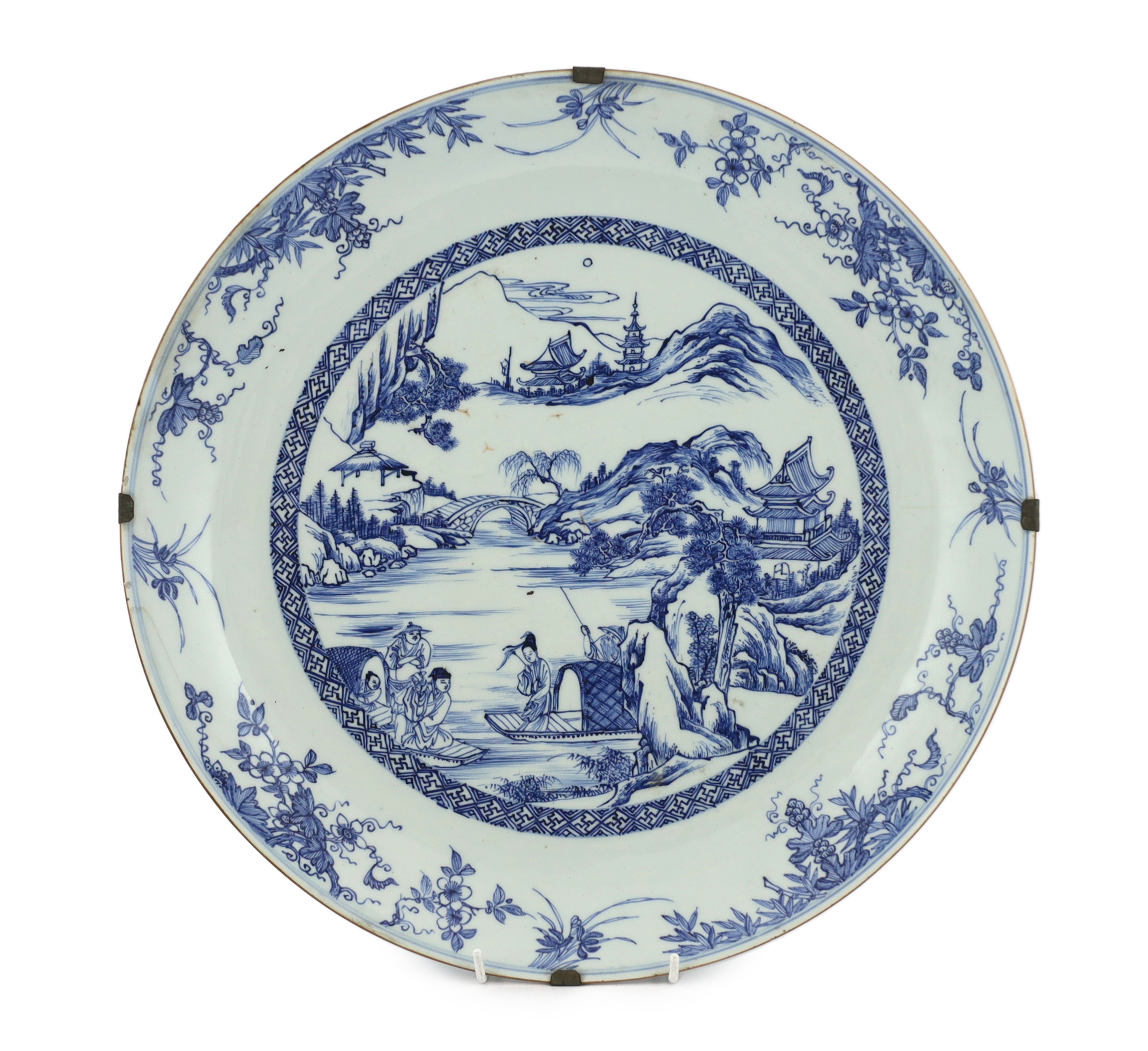 A Chinese blue and white landscape dish, Yongzheng/Qianlong period, short hairline crack